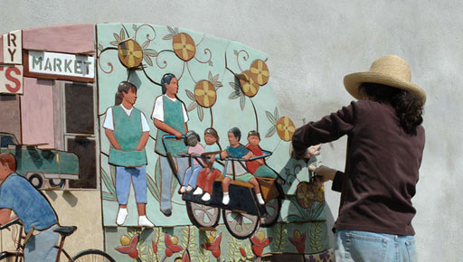 Judith puts up a section of the Immokalee (2007) Mural